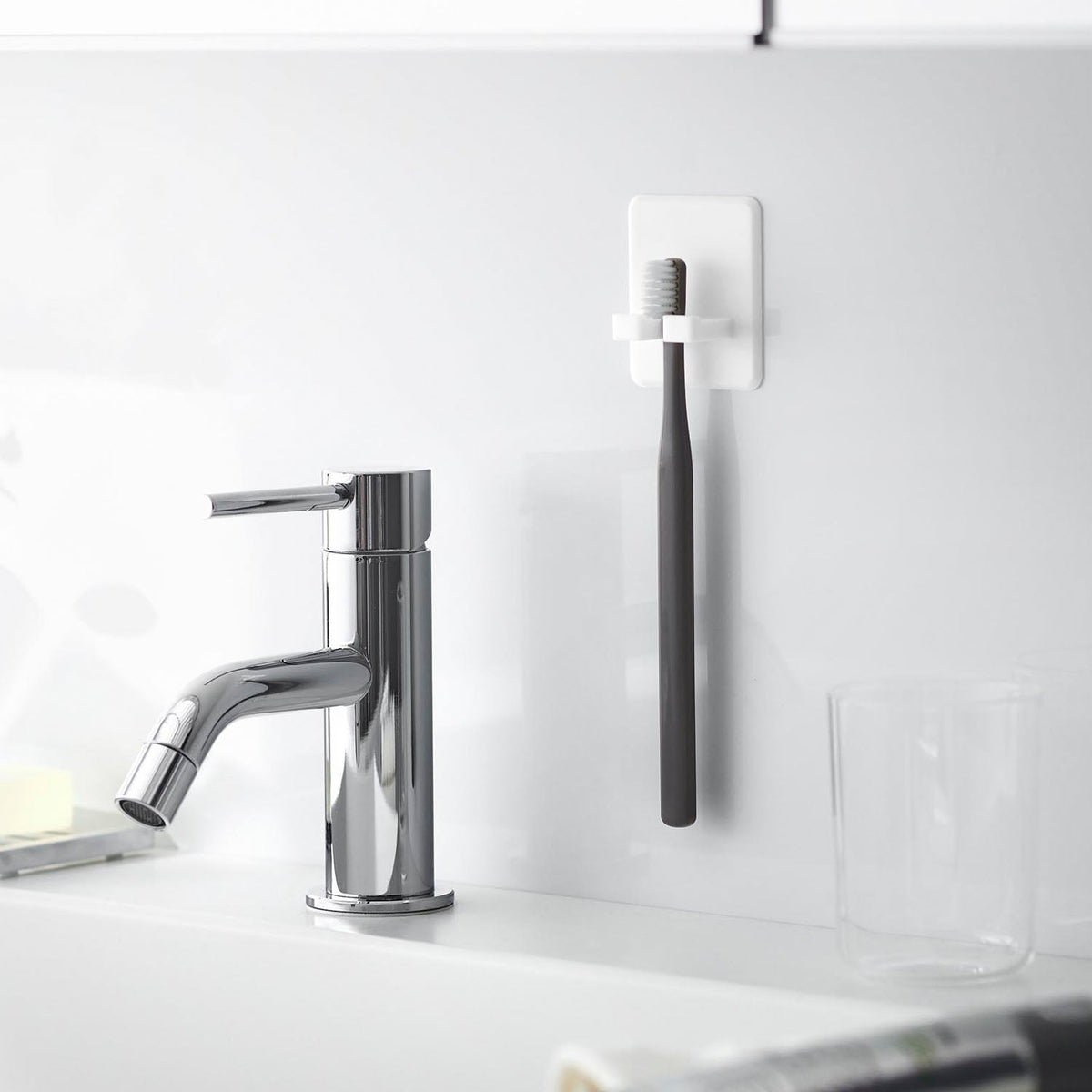 Yamazaki Tower Silicone Suction Toothbrush Holder, Silicone Suction Holder that Floats A toothbrush on a Glossy Wall so Water Drains Off, Peel It Off to Wash and Re-Stick, Heat Resistant to 250 C, 5.2 x 2.3 x 6 cm and 15 g, White or Black