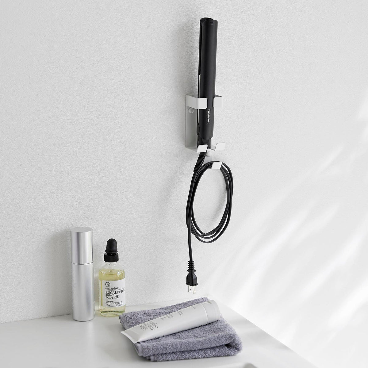 Yamazaki Tower Wall-Mounted Hair Iron Holder, Wall Holder for a Daily Hair Iron on the Washroom Wall, Cord Slit and Cord Hook Keep the Cord Tidy, Holds 1 kg, 5.5 x 6 x 13.7 cm and 160 g, White or Black