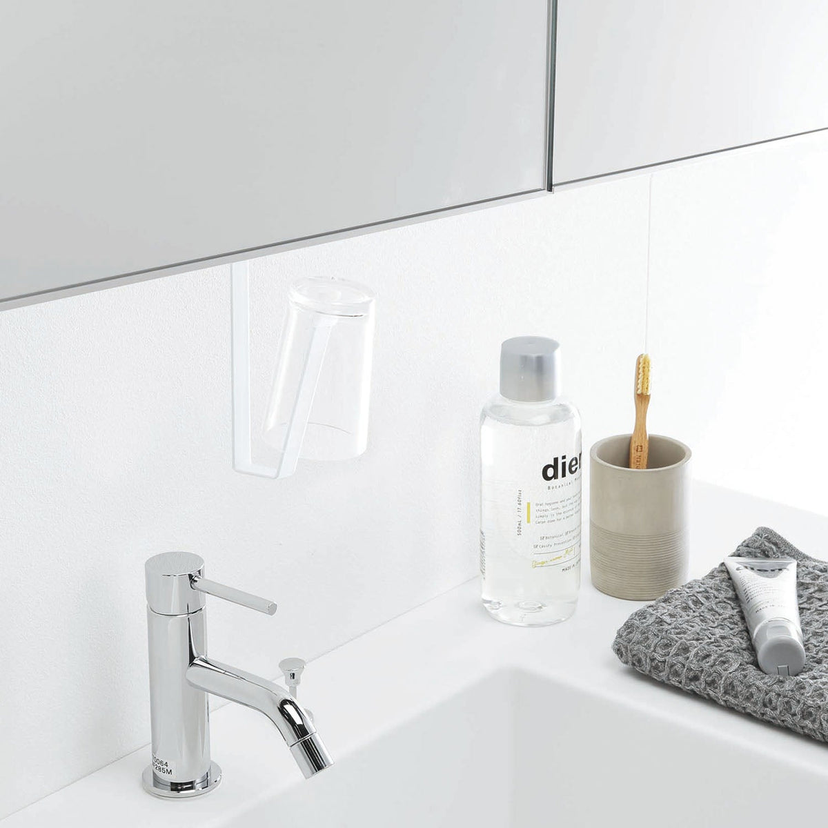 Yamazaki Tower Washbasin Under-Cabinet Tumbler Holder, Slim Holder That Clamps to the Shelf of a Wall Cabinet Over a Washbasin and Hangs a Tumbler Upside Down in the Dead Space So It Dries, Holds 250 g, 1.8 x 8 x 19 cm and 115 g, White