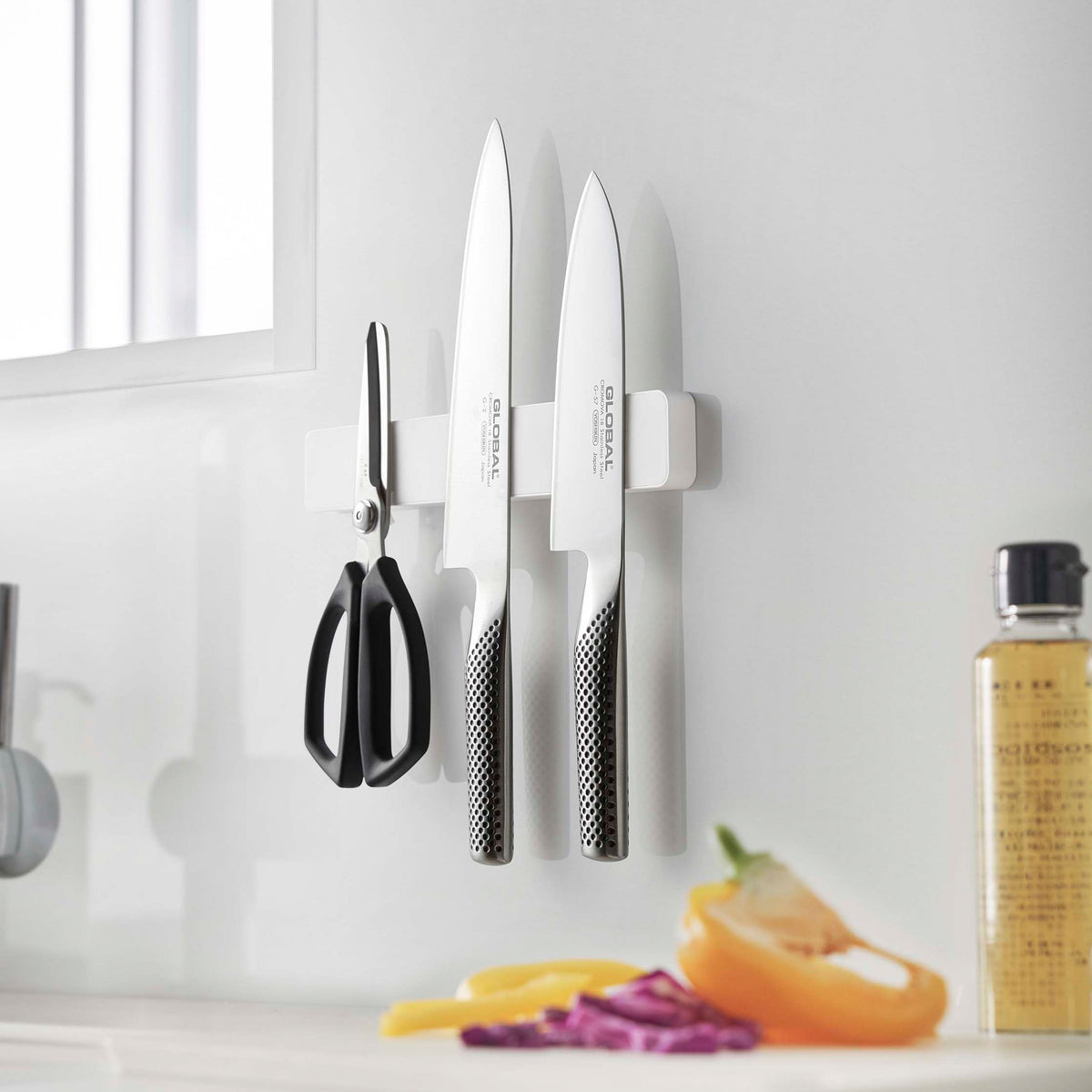 Yamazaki Tower Magnetic and Wall Knife Holder W25, Slim 25 cm Knife Bar That Fixes by Magnet, Screws or Tape and Holds Up to Four Knives Without Scratching Them, Silicone Contact Face, Holds 1.5 kg, 25 x 1.7 x 4 cm and 330 g, White or Black