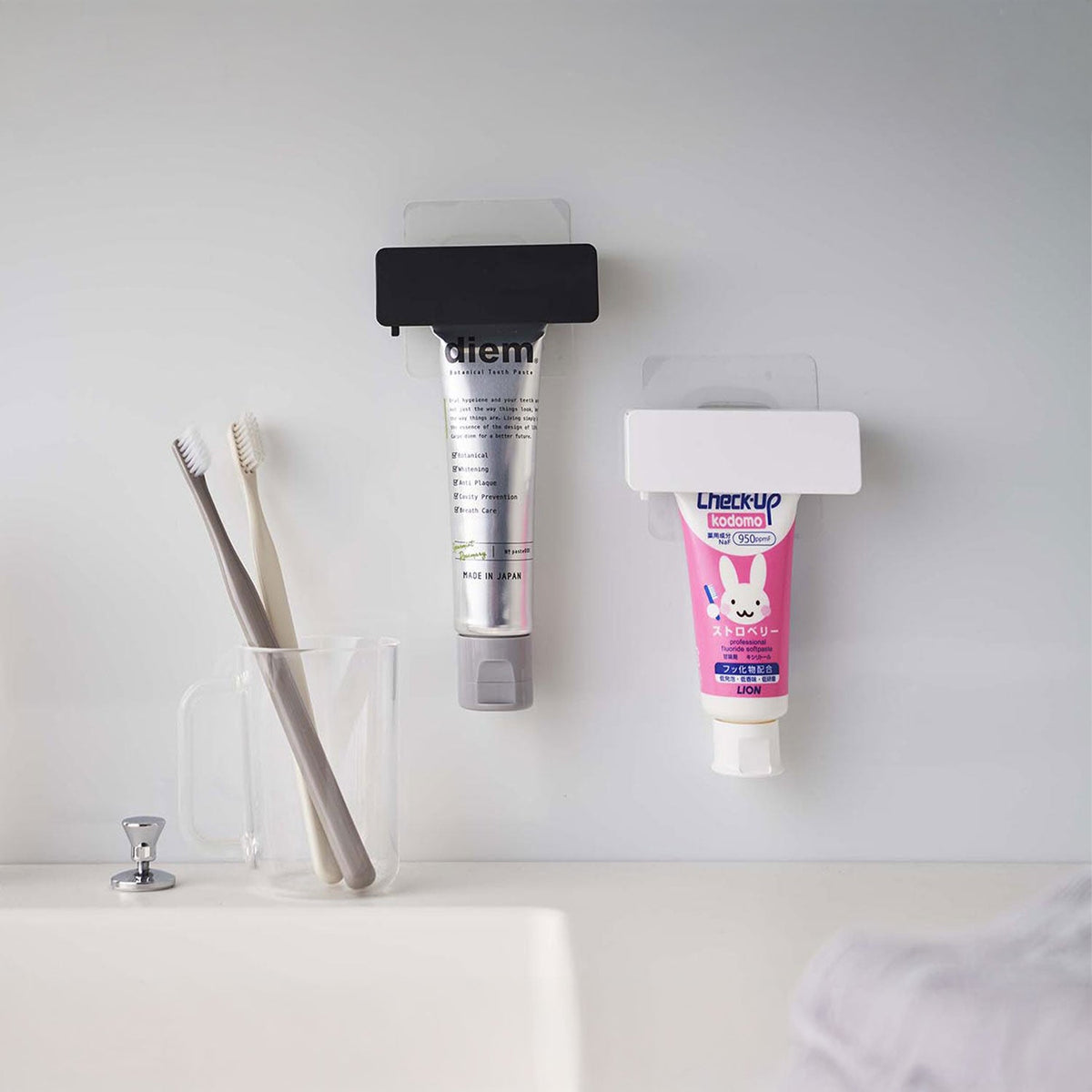Yamazaki Tower Film-Hook Toothpaste Tube Holder, Holder on a Film Hook That Floats a Toothpaste Tube on the Bathroom Wall and Squeezes Out the Last Bit by Turning the Handle, Holds 250 g, 9 x 3.5 x 3.5 cm and 60 g, White or Black