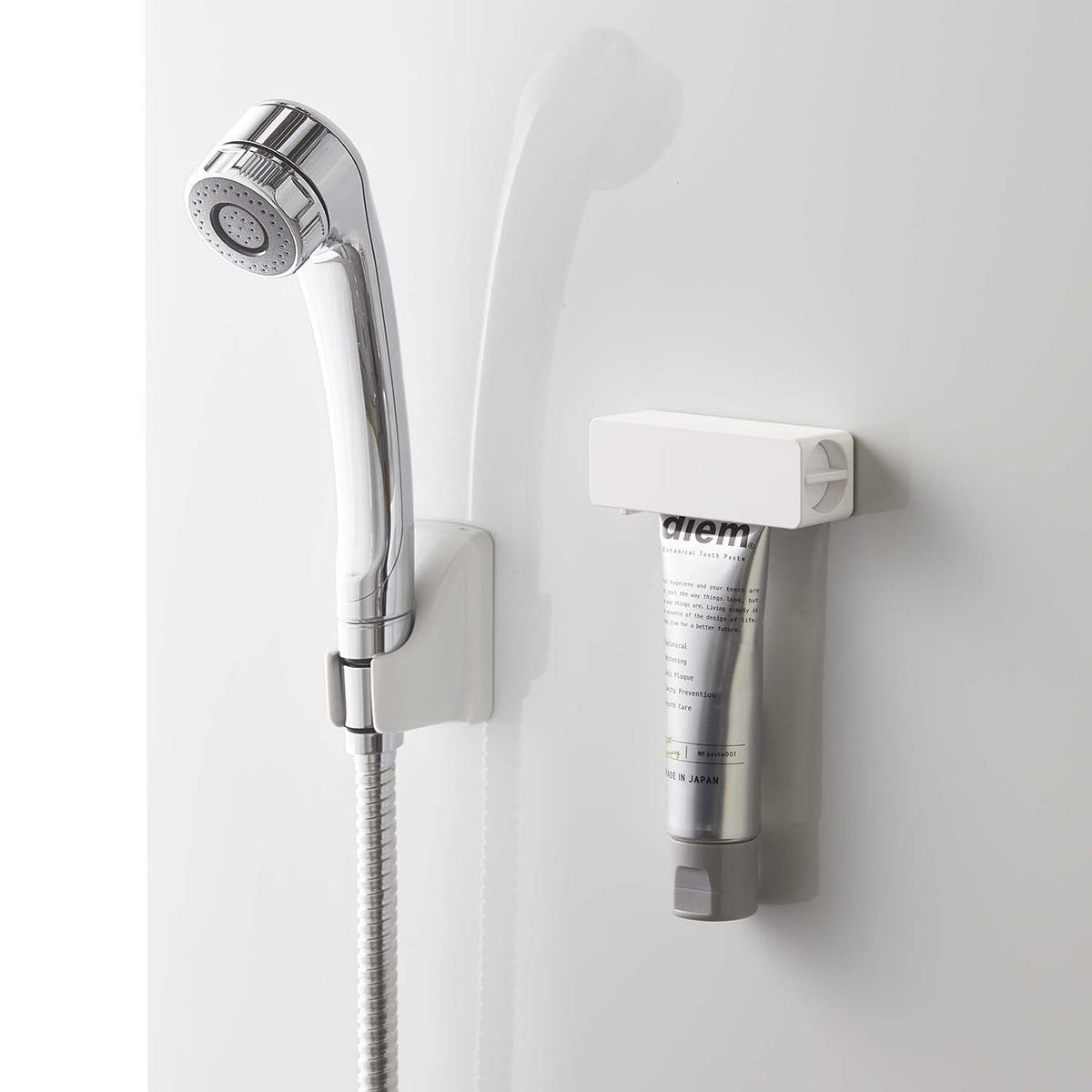 Yamazaki Tower Magnetic Toothpaste Tube Holder, Holder With a Magnet That Floats a Toothpaste Tube on a Steel Bathroom Wall and Squeezes Out the Last Bit by Turning the Handle, Easy On and Off, Holds 250 g, 9 x 3 x 3.5 cm and 60 g, White or Black