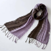 Close-up of a hand-dyed brown-purple mud dye cotton scarf from Amami Oshima showing rich texture and natural color variation.