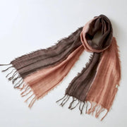 Hand-dyed Amami Oshima mud-dye cotton scarf in earthy brown and tan tones showing the unique texture of Dorozome