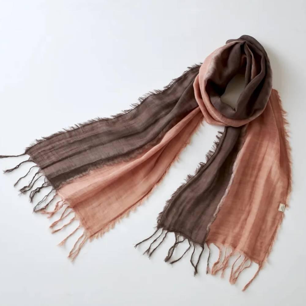 Hand-dyed Amami Oshima mud-dye cotton scarf in earthy brown and tan tones showing the unique texture of Dorozome