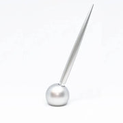 Delight Labo Sand Silver Ballpoint Pen standing upright in its matching elegant metal stand on a desk