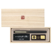 Kuretake Gold-Accented Black Leather Fountain Brush Pen with three ink cartridges in a premium presentation box