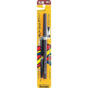 Kuretake No. 8 Fountain Brush Pen with two ink refills on a professional calligraphy desk