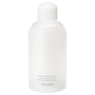 Kose DECORTE Microbalm Lotion bottle on a reflective surface, showcasing its luxurious packaging and texture.