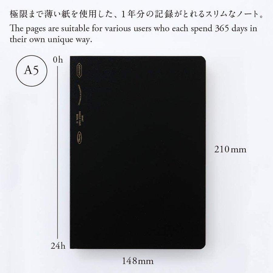 Nitto Stalogy A5 365Days Grid Notebook with minimalist black cover and gold lettering showing lay-flat binding