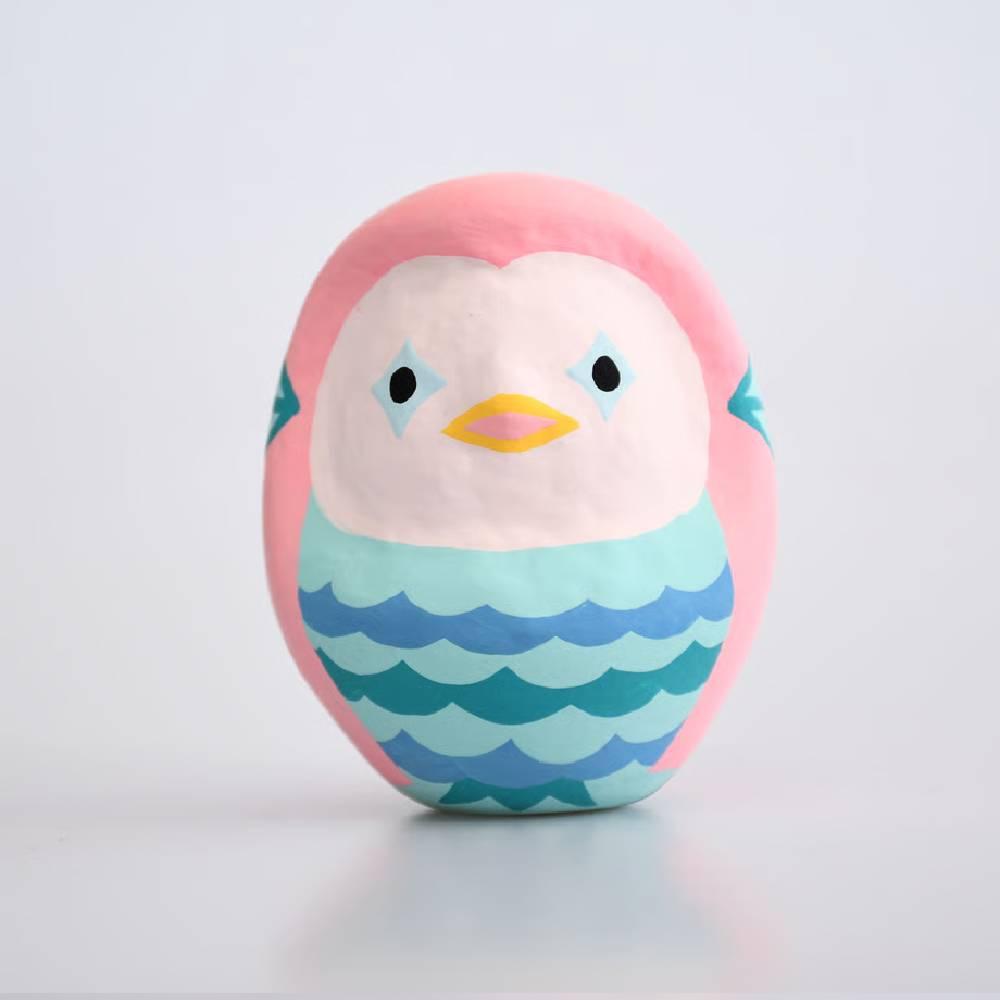 Handcrafted pink Shirakawa Amabie Daruma doll with intricate gold detailing and traditional Japanese features