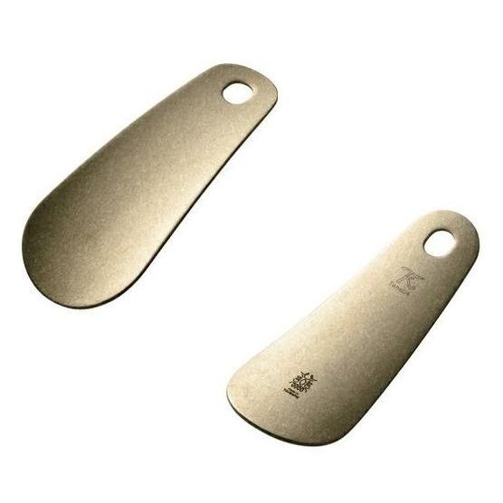 Tanabe Handcrafted Brass Shoehorn with textured matte finish next to a premium navy gift box