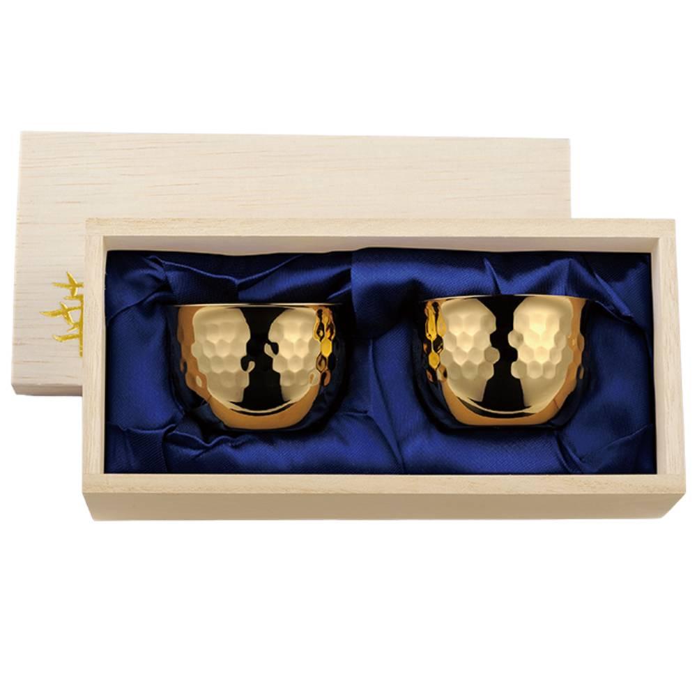 A pair of hand-hammered copper sake cups with 24K gold plated interiors, made by Tanabe in Japan.