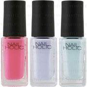 Kose Nail Holic Milky Color nail polish bottles in various pastel shades displayed on a white background.