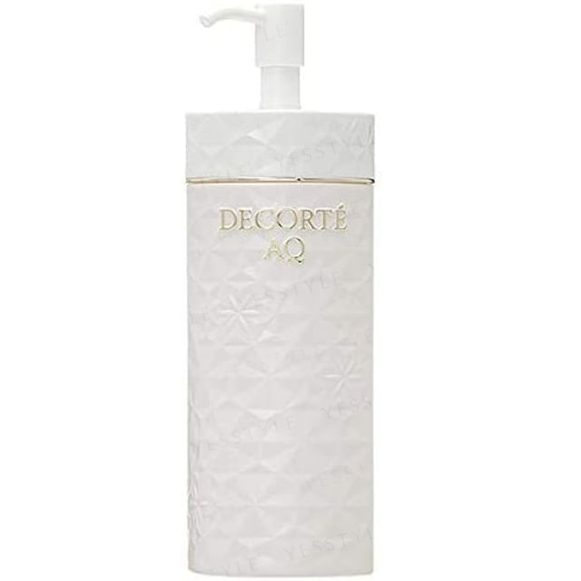 Kose DECORTE AQ Cleansing Oil bottle on a soft, glowing background