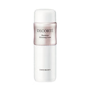 Kose DECORTE Phytotune Whitening Tuner bottle with product application on cotton pad, showcasing radiant skin