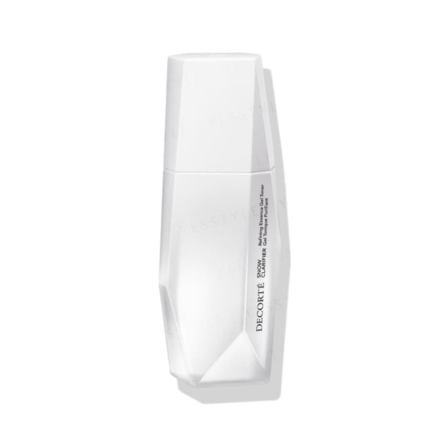 Kose DECORTE Snow Clarifier Essence bottle on a clean, bright surface showcasing its clarity and luxurious design.