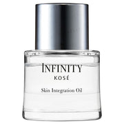 Kose INFINITY Skin Integration Oil bottle on a reflective surface showcasing its luxurious texture and radiant results.