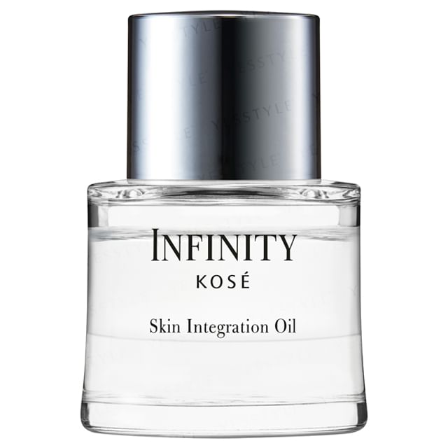 Kose INFINITY Skin Integration Oil bottle on a reflective surface showcasing its luxurious texture and radiant results.