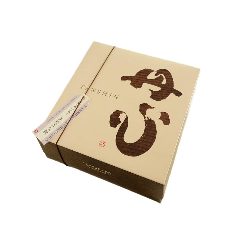 Yanagawa Handmade Kuromame Kinako Baumkuchen showing detailed layers and rich brown texture on a wooden serving board