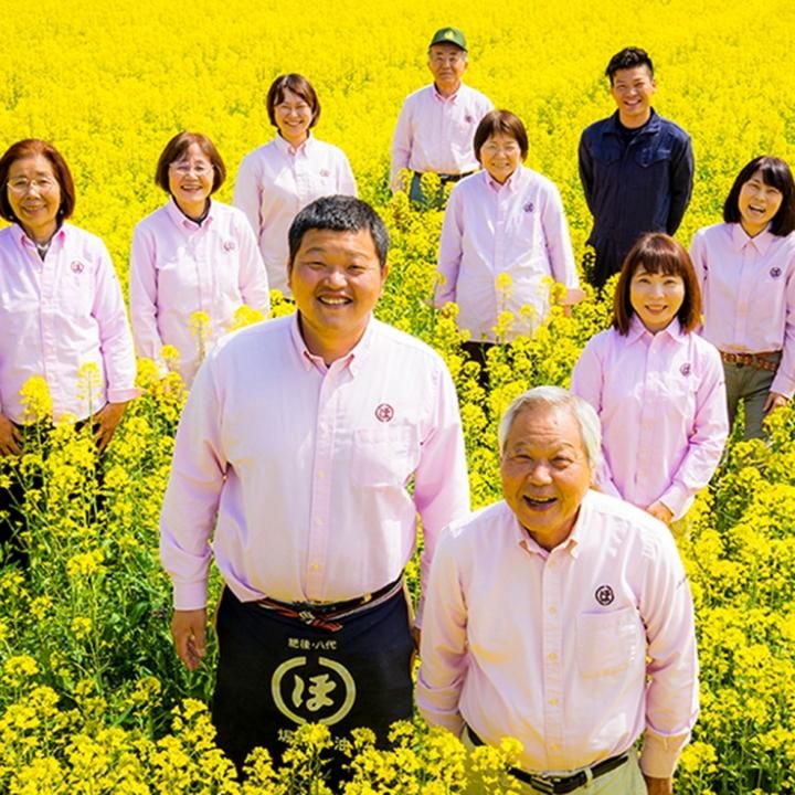 Horiuchi team standing in a flowering field